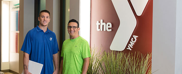 Two men standing in front of the YMCA