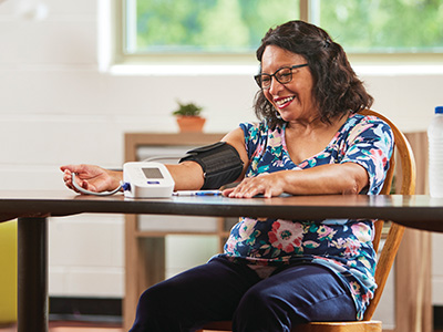 Photo of a woman checking her blood pressure