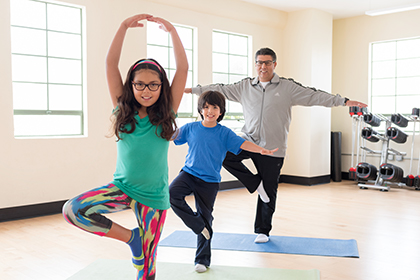 Photo of a family of three exercising together