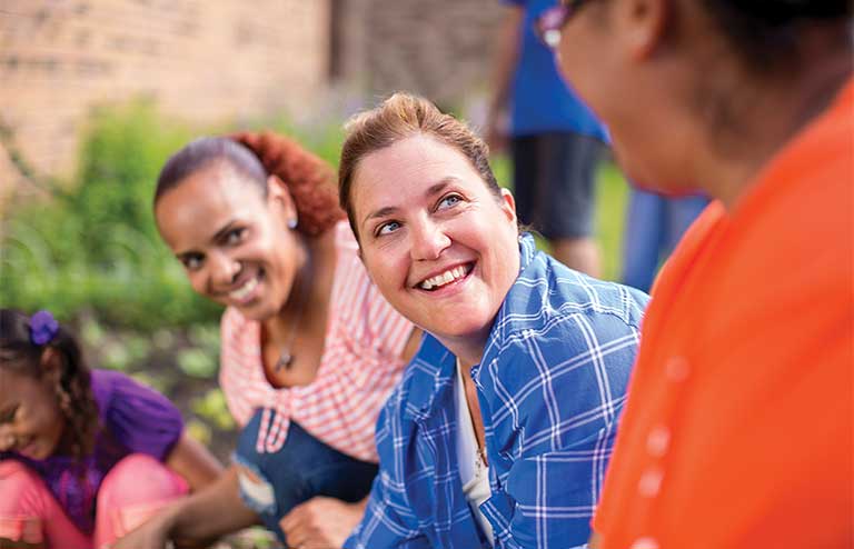 Photo of a happy woman working together with the YMCA