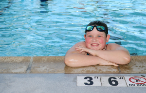 girl swimming in pool smiling