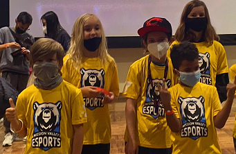 Photo of an esports team wearing matching yellow shirts and face masks