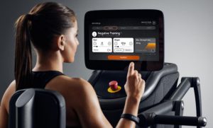 Woman selecting her exercise on an Egym machine