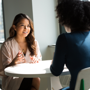 Person receiving health coaching at a table.