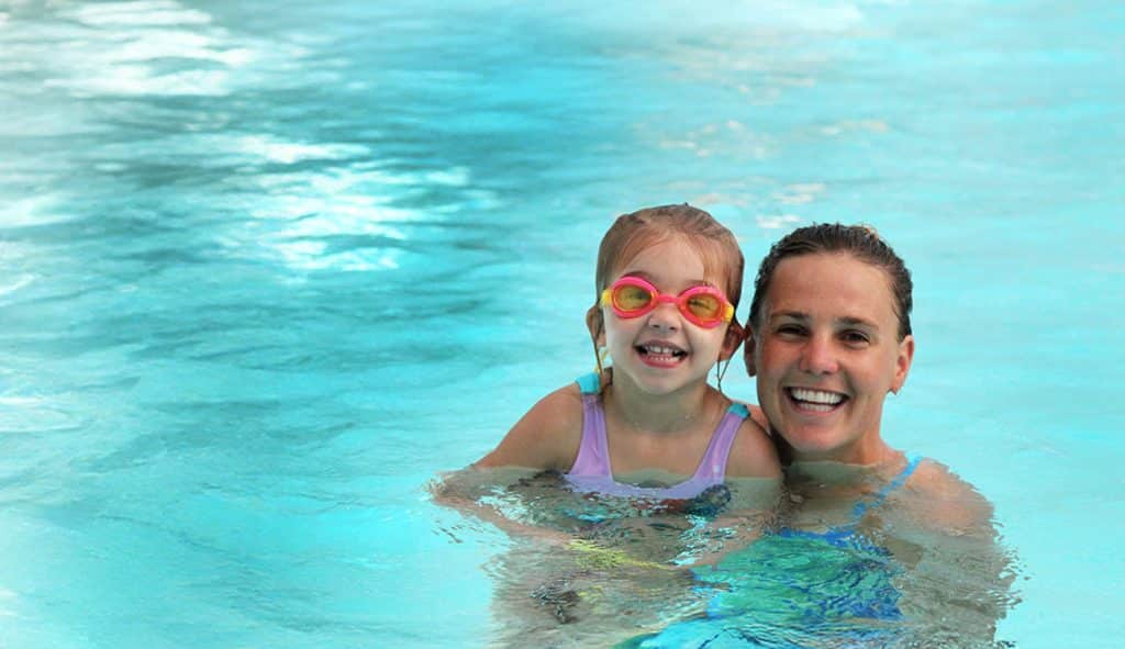 mom in pool with child