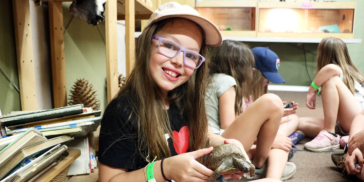 girl with turtle at camp